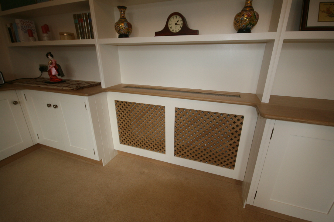 Back to Bookshelves and Cupboards surrounding Bespoke Radiator Case with Oak Trellis and TV unit.