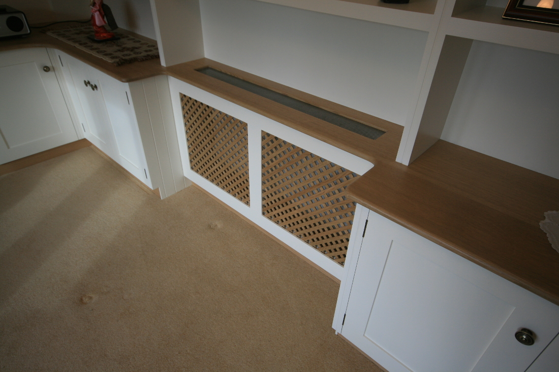 Back to Bookshelves and Cupboards surrounding Bespoke Radiator Case with Oak Trellis and TV unit.