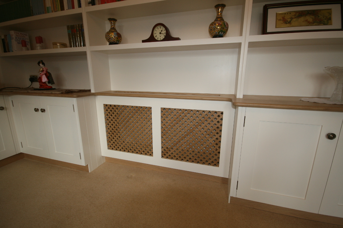 Back to Bookshelves and Cupboards surrounding Bespoke Radiator Case with Oak Trellis and TV unit.