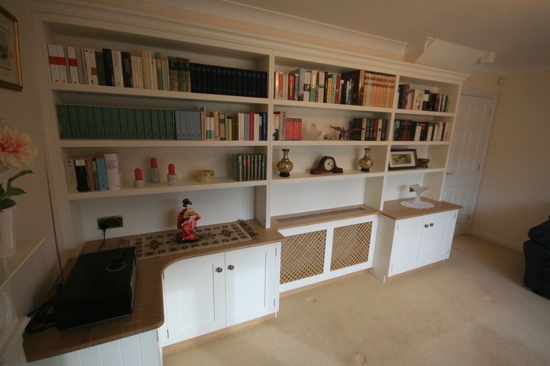 Back to Bookshelves and Cupboards surrounding Bespoke Radiator Case with Oak Trellis and TV unit.