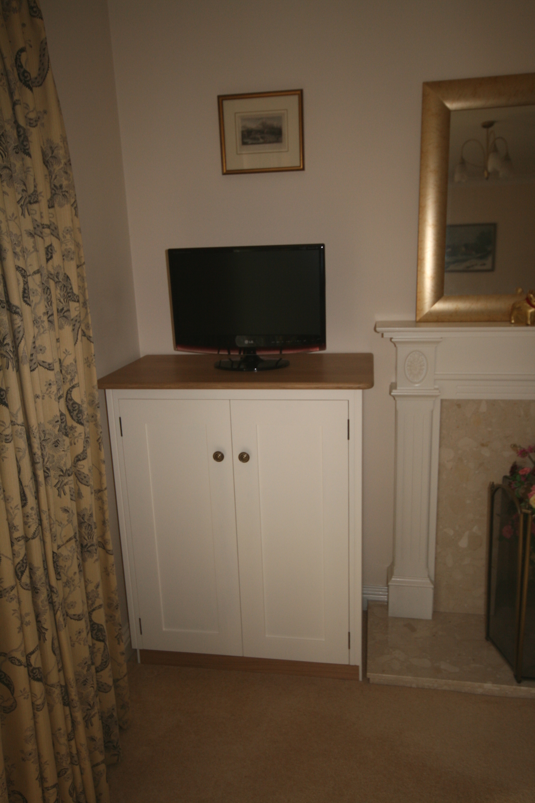 Back to Bookshelves and Cupboards surrounding Bespoke Radiator Case with Oak Trellis and TV unit.
